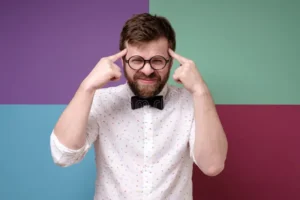 bearded man round glasses trying to remember something trying very hard to gather his thoughts bearded man round 169702298