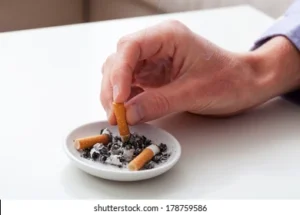 hand putting cigarette on ashtray 260nw 178759586