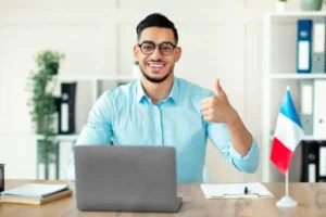 online french lesson foreign languages tutor teaching class web using laptop pc showing thumb up home office positive arab 354643195