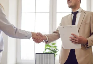 confident diverse business people shaking hands office close up customer giving handshake to manager lawyer ending meeting 398086463