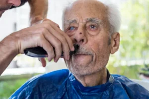elderly men getting his beard shaved young skilled men home old man getting his beard shaved young skilled man home 118489309