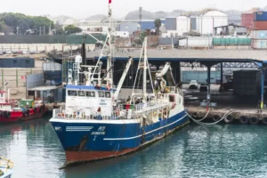fishing vessel moored port callao peru vessel has blue white hull equipped cranes hauling nets 404099899