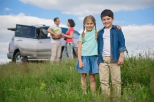 happy family enjoying road trip summer vacation love trips little brother sister standing together embracing each other 76024966