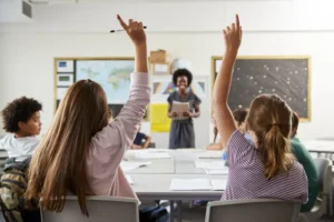 high school students raising hands to answer question set teacher classroom 134207290