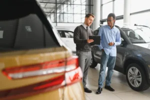 male car dealer helps customer choose dealership man buys new 403940284