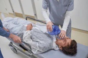 man lying on hospital stretcher 600nw 2645711831