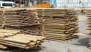 pile of stacked wooden planks at a construction site wooden boards lumber industrial edged timber wooden rafters for the repair or construction of a private house roofing and joinery lumber photo