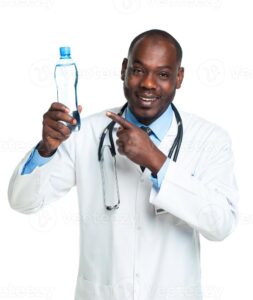 portrait of a smiling male doctor holding bottle of water on white photo
