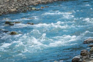 stones water riffle mountain river powerful stream creek rapids fast flow rocks highland brook small close up 182549015