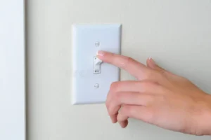woman turning off light switch 23400941