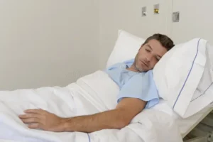 young patient man lying hospital bed resting tired looking sad depressed worried medical condition suffering disease 80457068